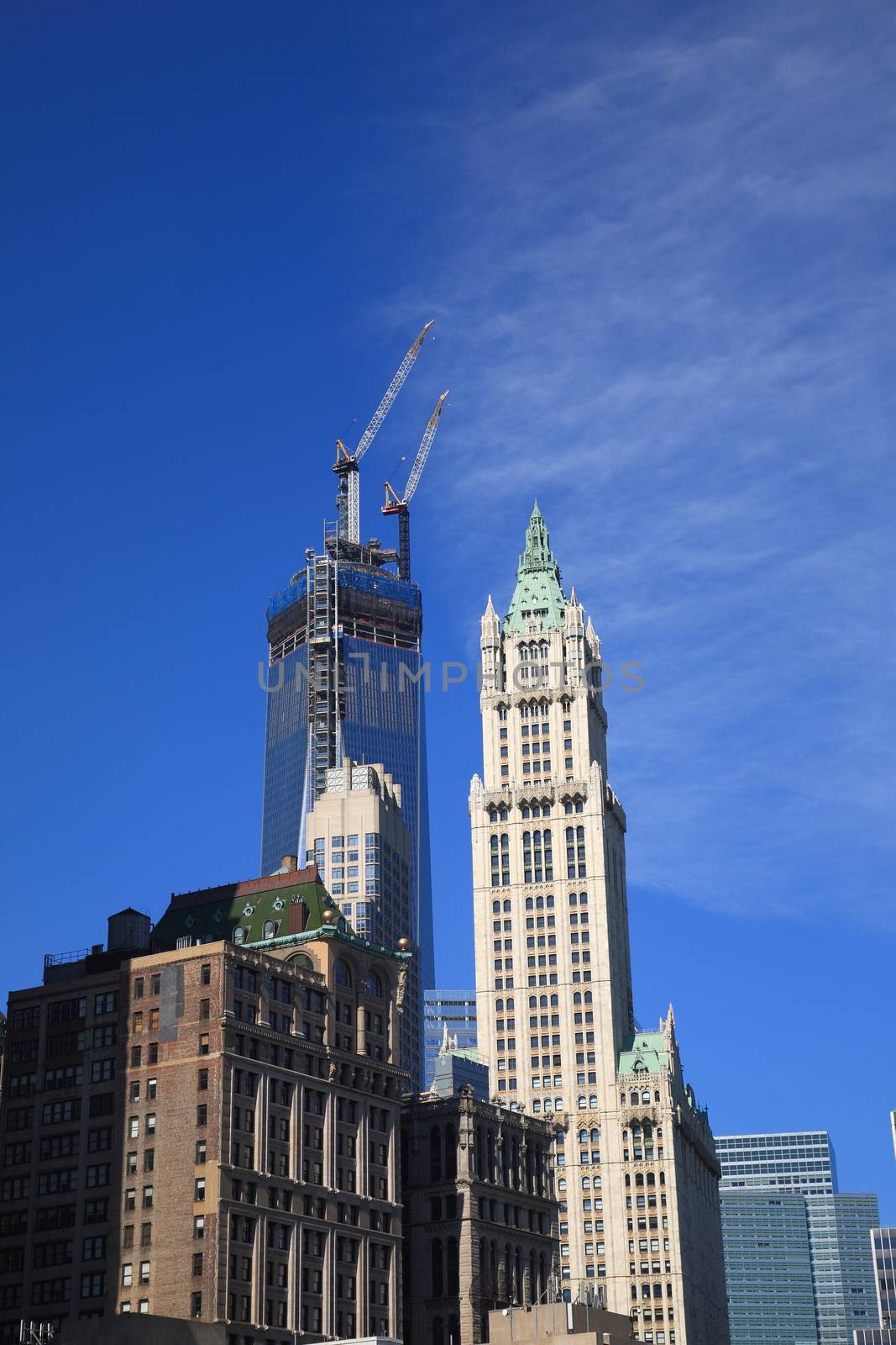 Rising Freedom Tower and vintage Woolworth Building in lower Manhattan.