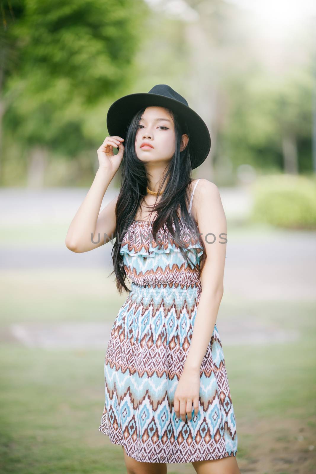 Beautiful girl is posing in vintage suit with black hat by nopparats