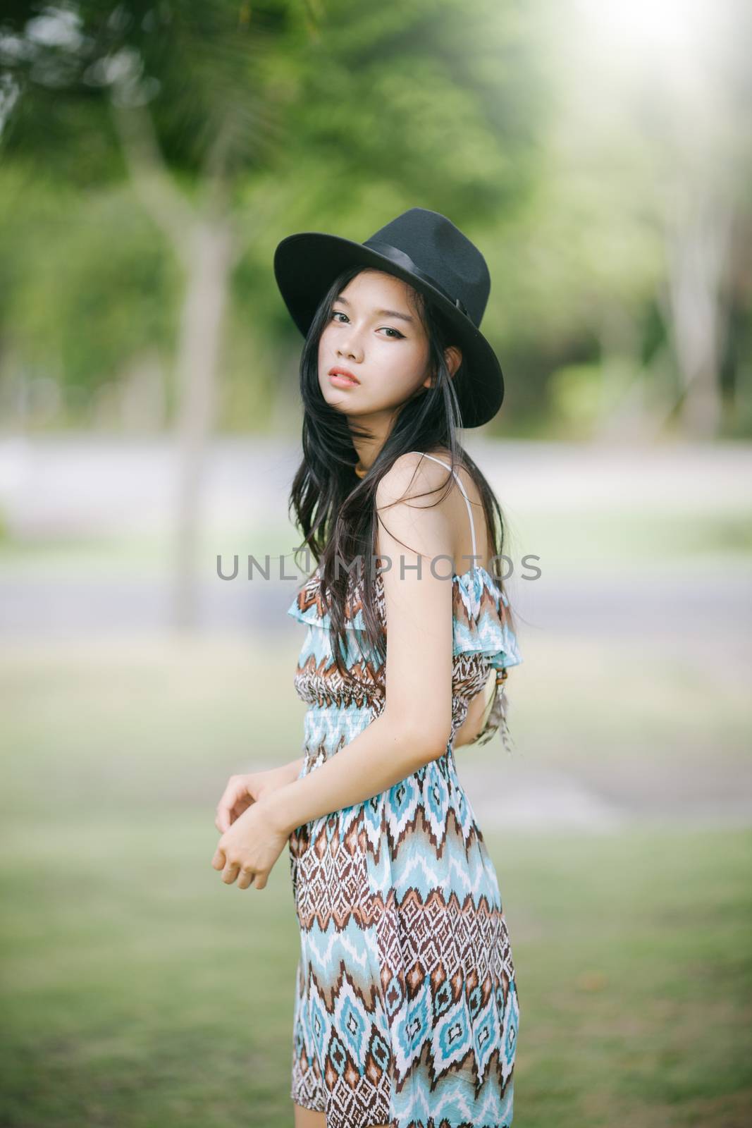 Beautiful girl is posing in vintage suit with black hat by nopparats