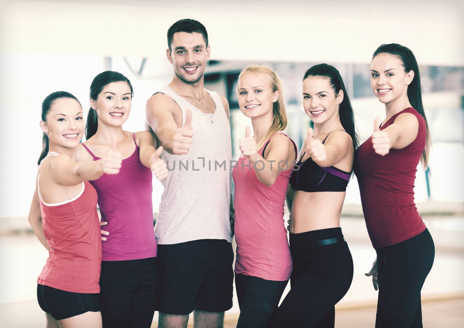 fitness, sport, training, gym and lifestyle concept - group of happy people in the gym showing thumbs up