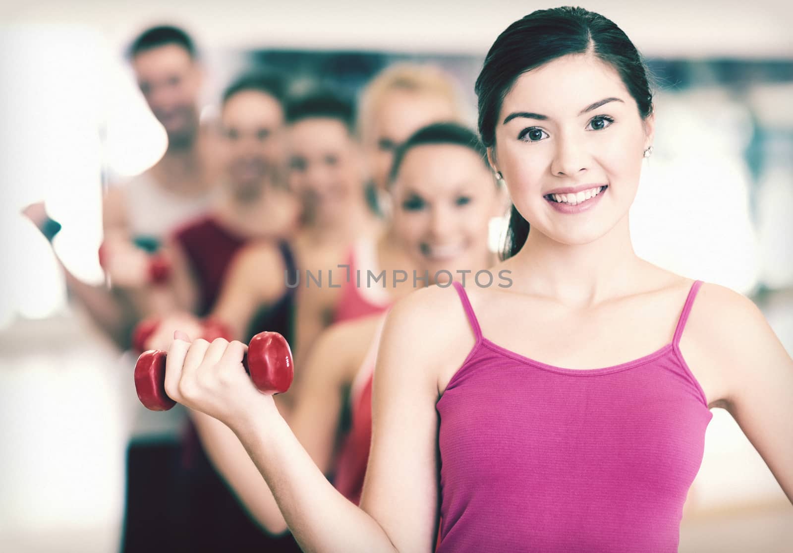 fitness, sport, training, gym and lifestyle concept - group of smiling people lifting dumbbells in the gym