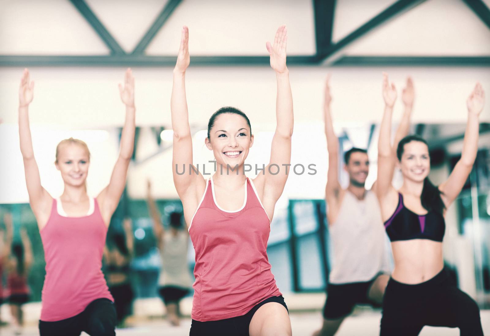 fitness, sport, training, gym and lifestyle concept - group of smiling people exercising in the gym