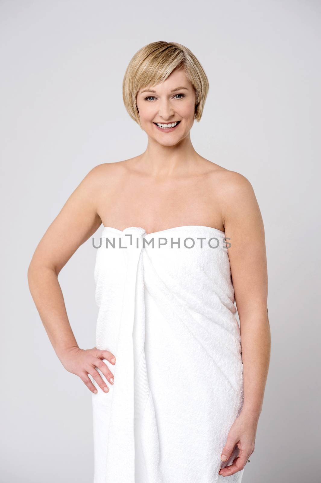 Smiling middle aged woman in towel after shower