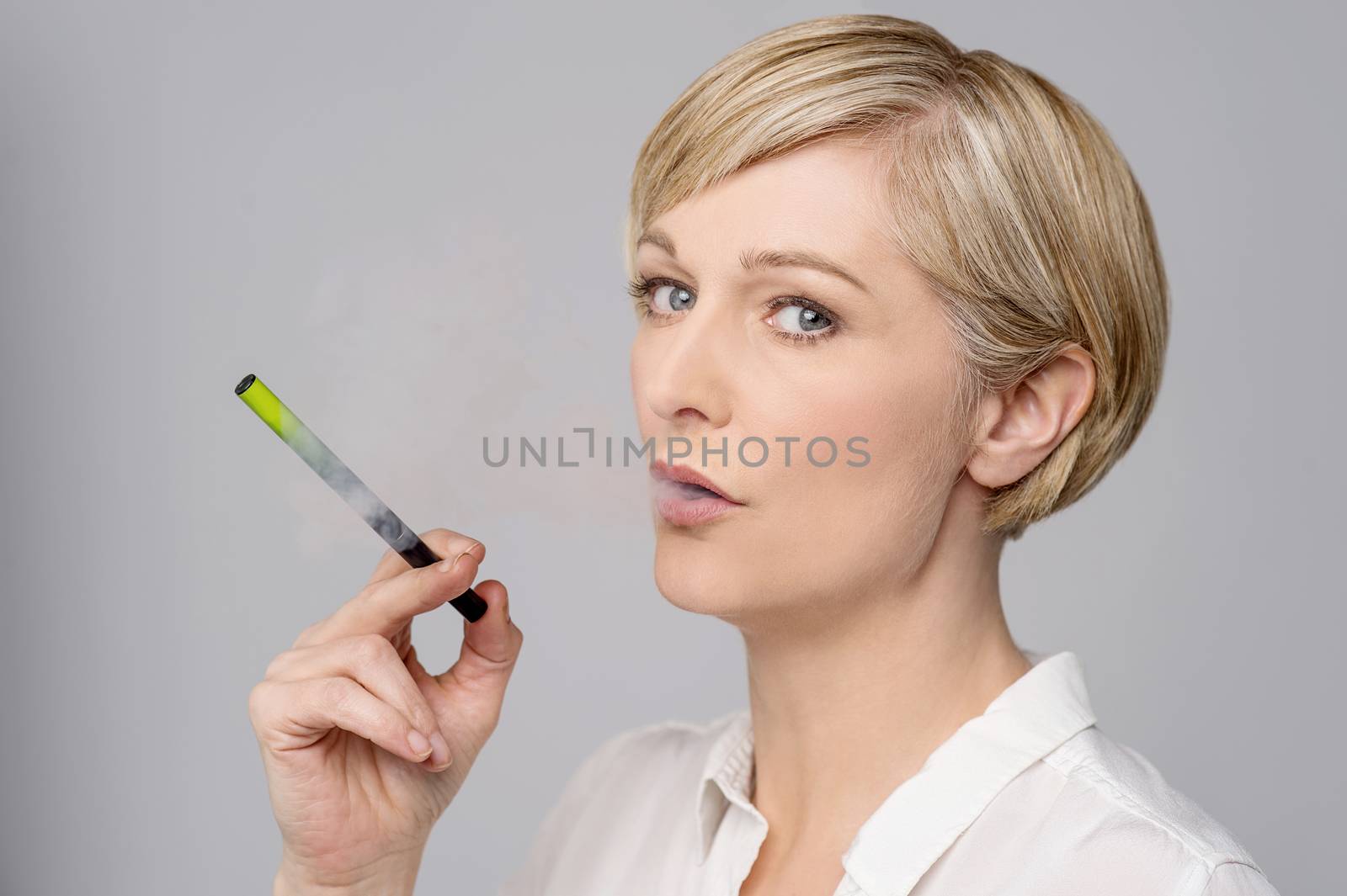 Woman with e-cigarette. by stockyimages