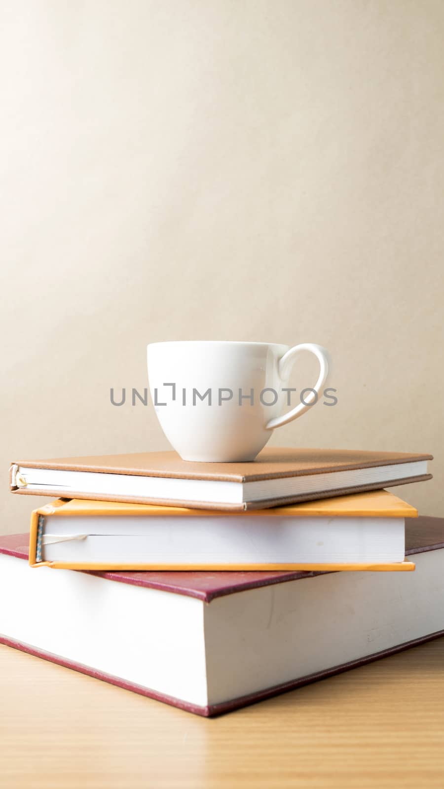 stack of book with coffee cup on wood table background