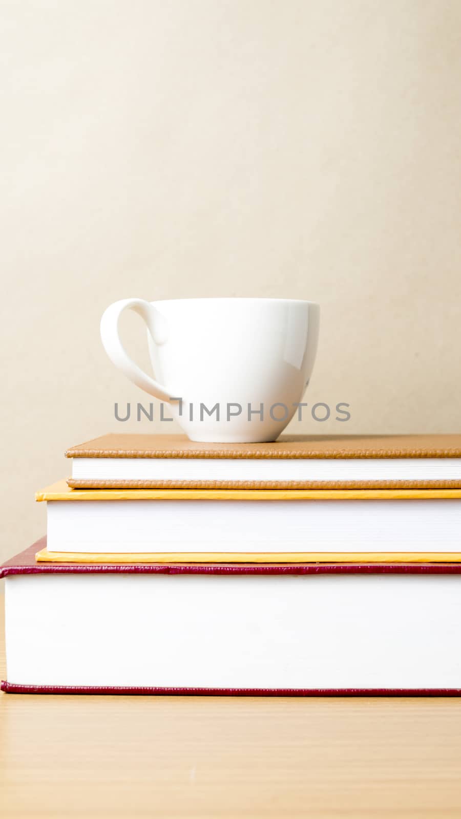 stack of book with coffee cup on wood table background