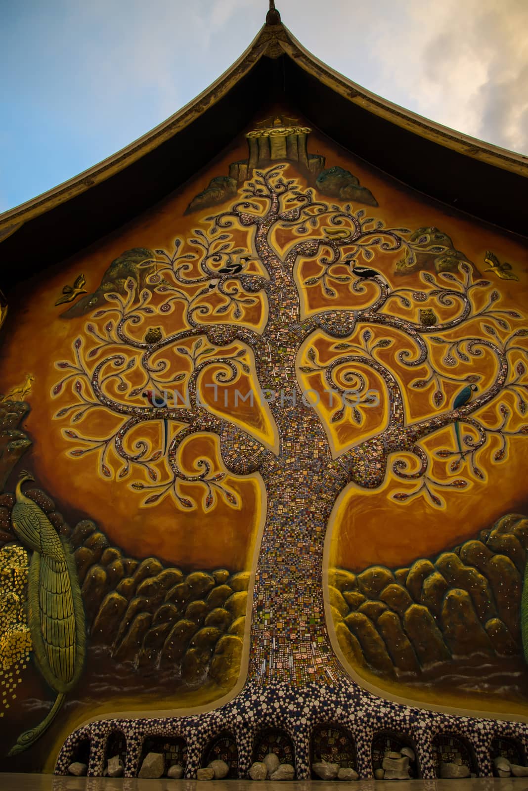 Art tree glow on the back of the hall of the temple in Thailand.
