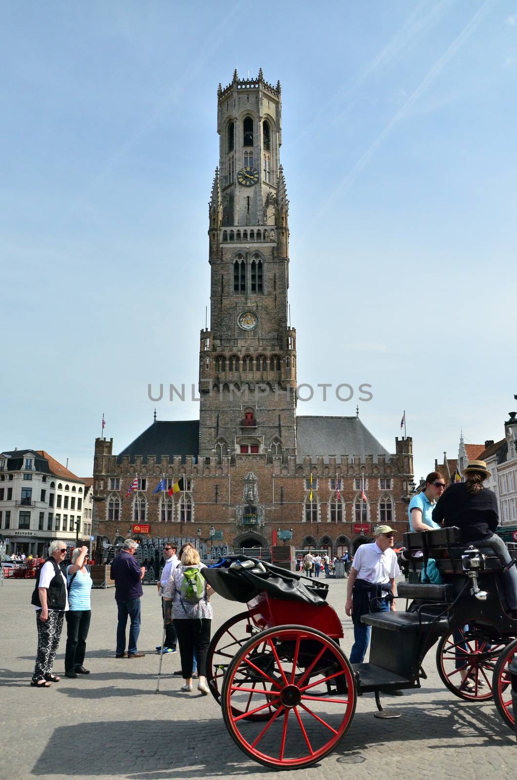 Bruges, Belgium - May 11, 2015: Tourist visit Belfry of Bruges on Grote Markt square on May 11, 2015. The historic city centre is a prominent World Heritage Site of UNESCO.