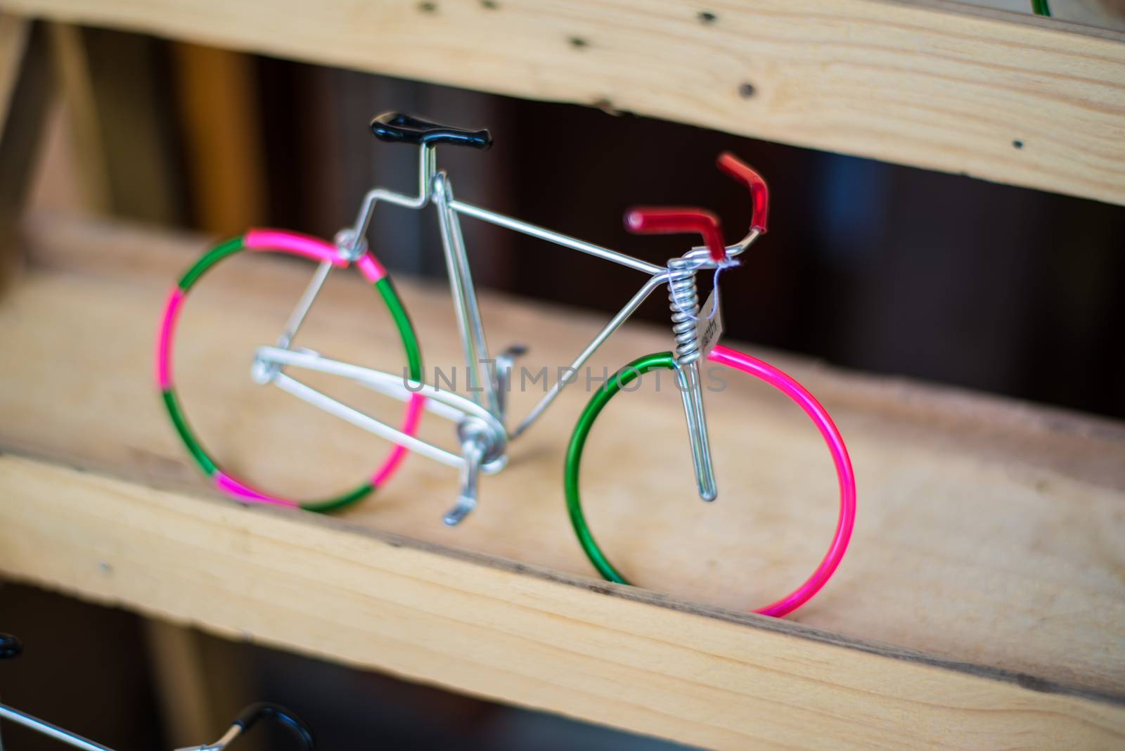 Miniature Bicycle  made of wire.Placed on wooden racks