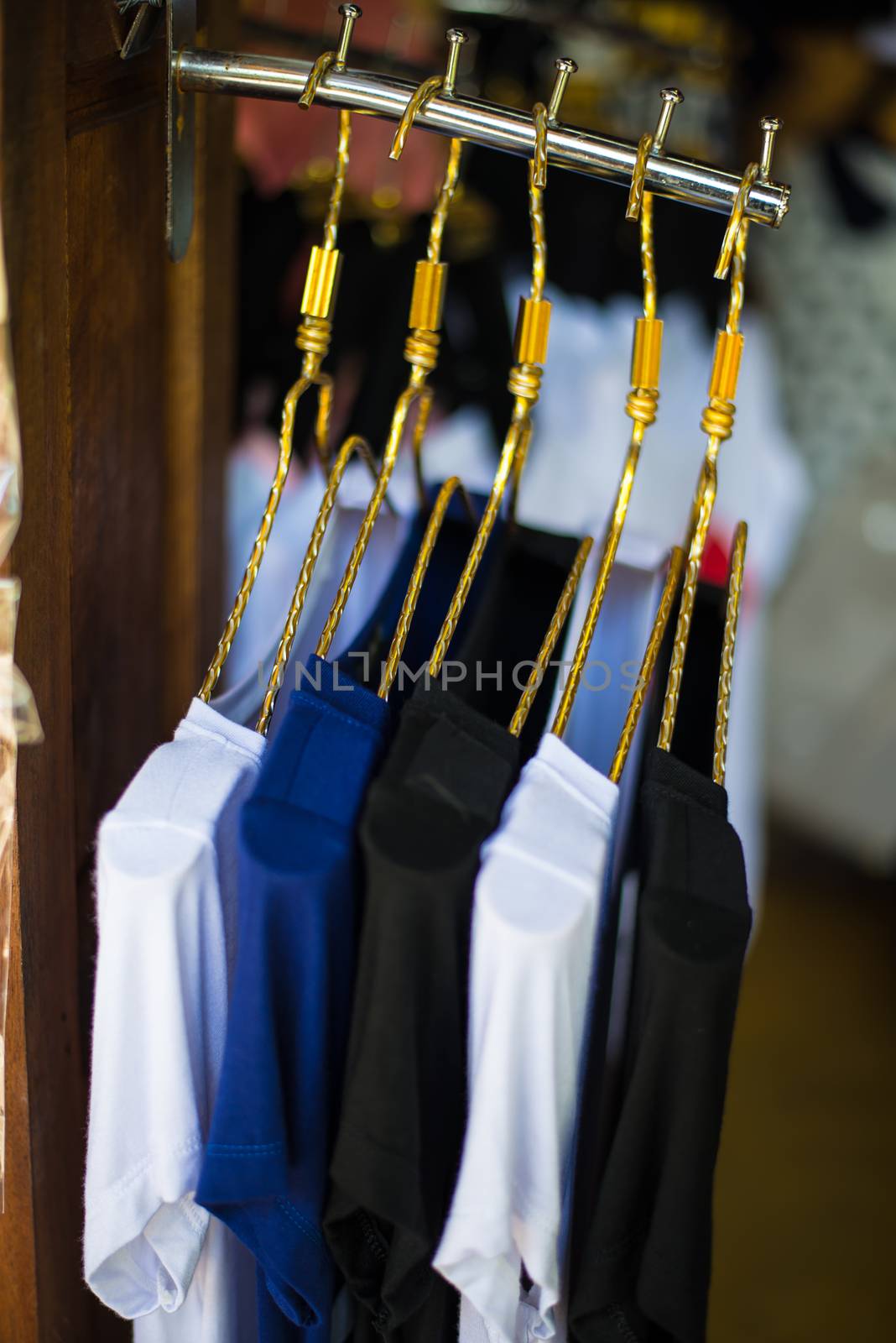 T-shirts hanging on a clothesline in a clothing store.