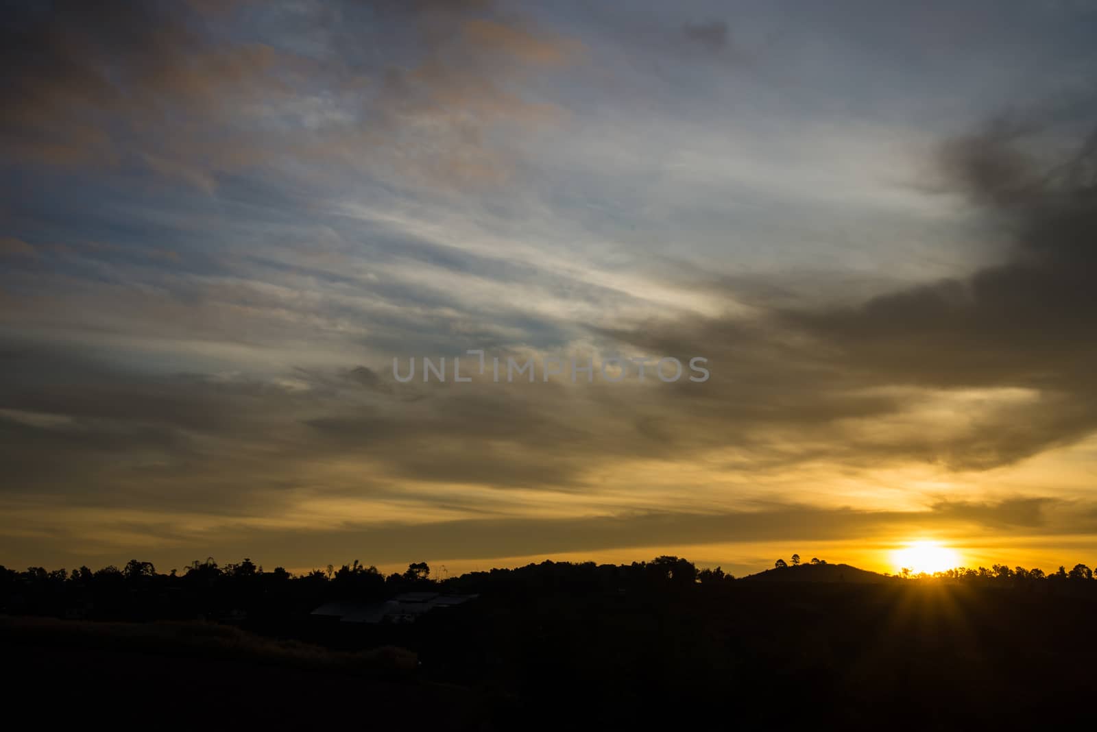 Sunrise in the morning, surrounded by mountains and meadows.