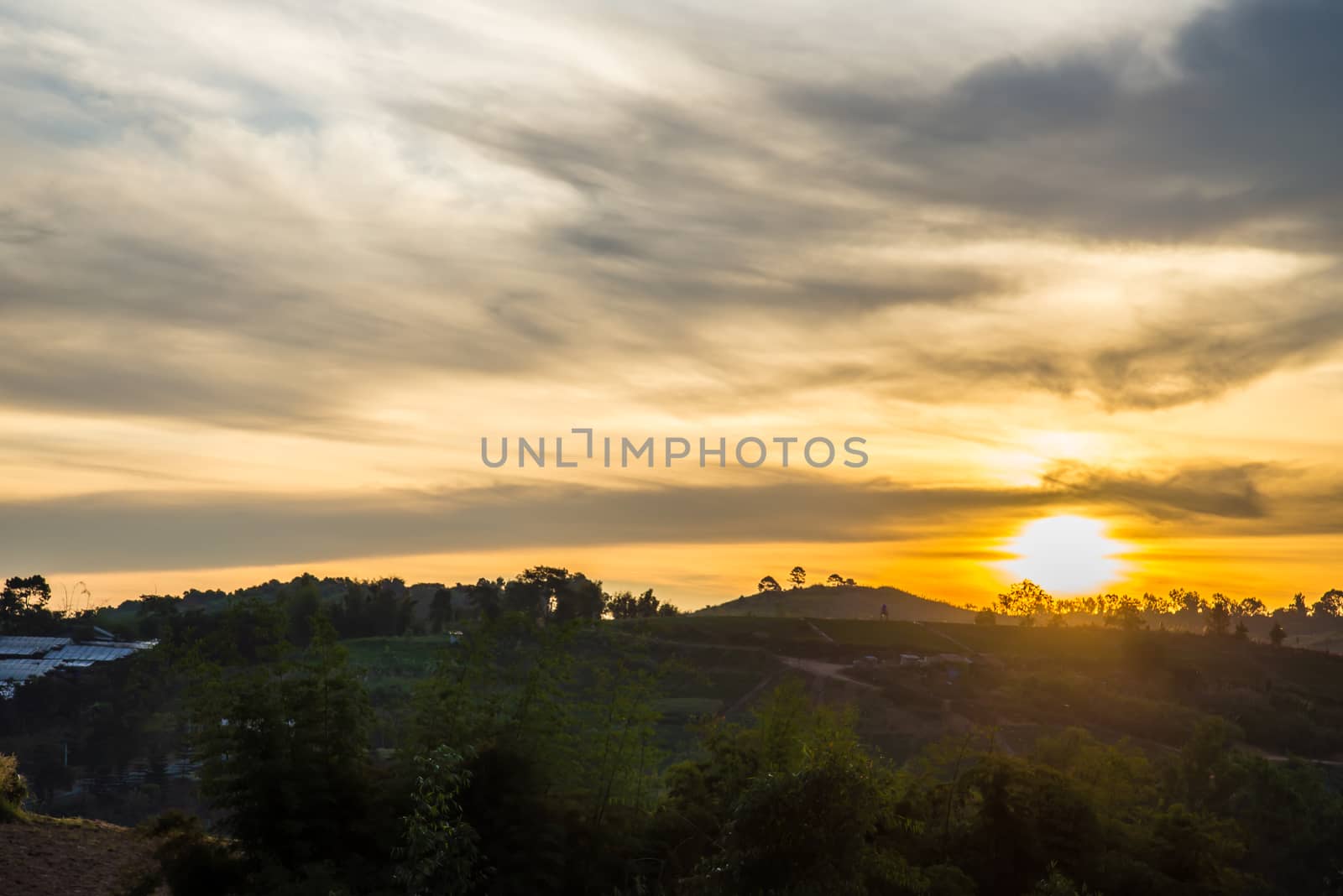 Sunrise in the morning, surrounded by mountains and meadows.