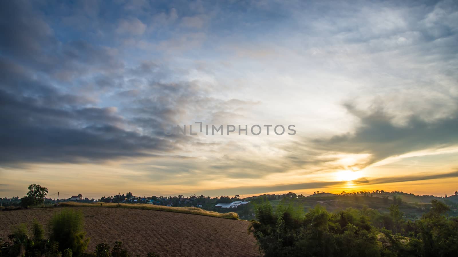 Sunrise in the morning, surrounded by mountains and meadows.