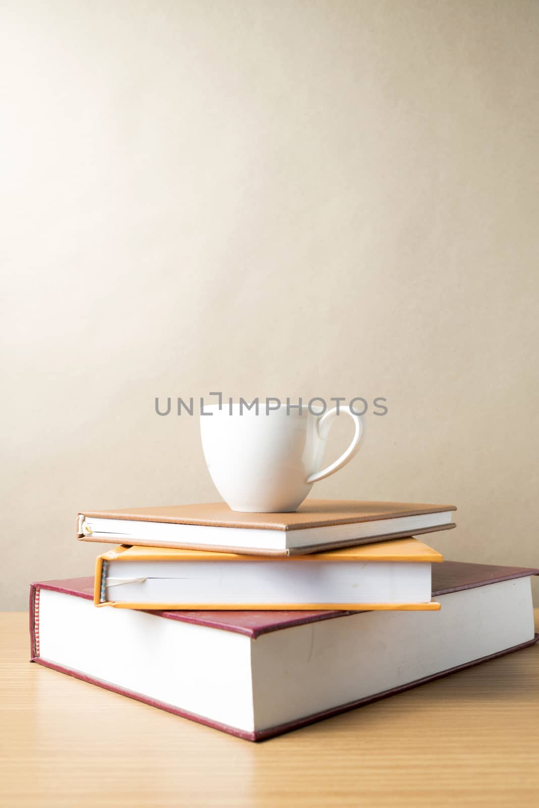 stack of book with coffee cup on wood table background