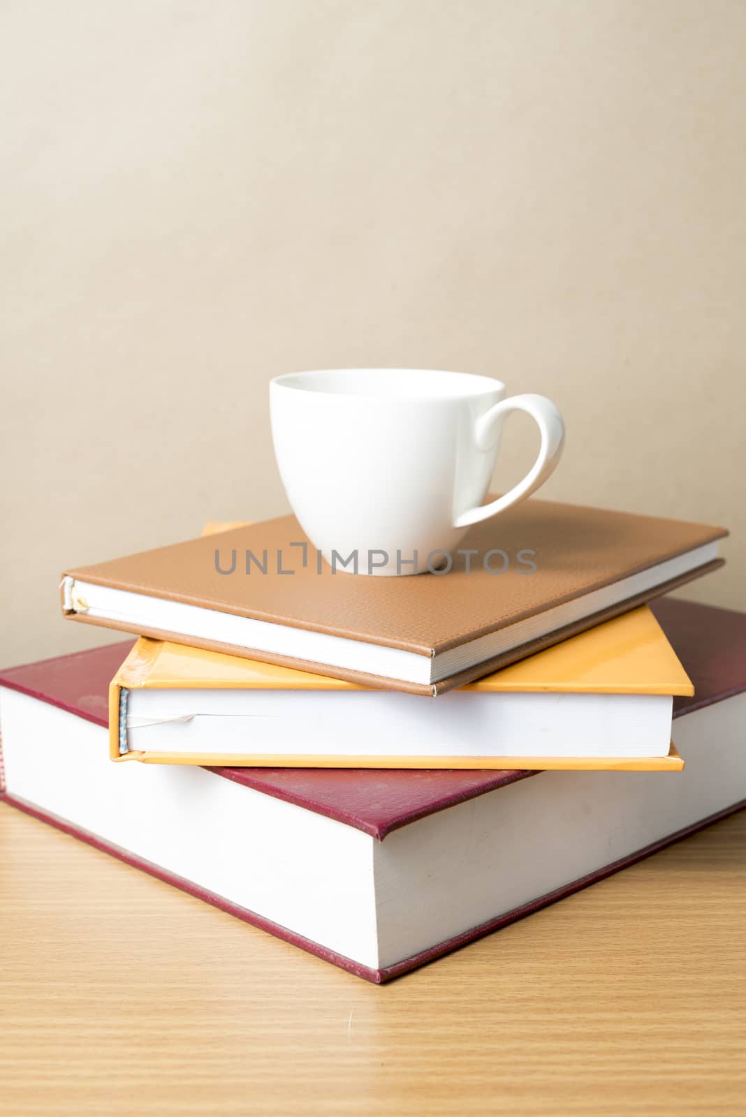 stack of book with coffee cup on wood table background