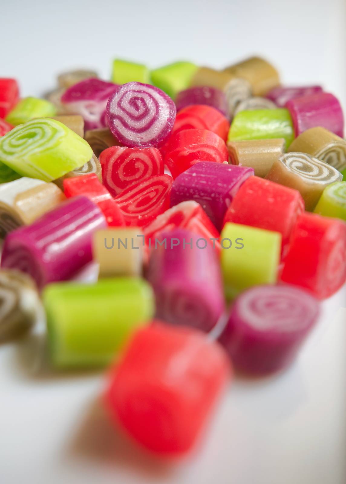 Colorful candies on white background by anderm