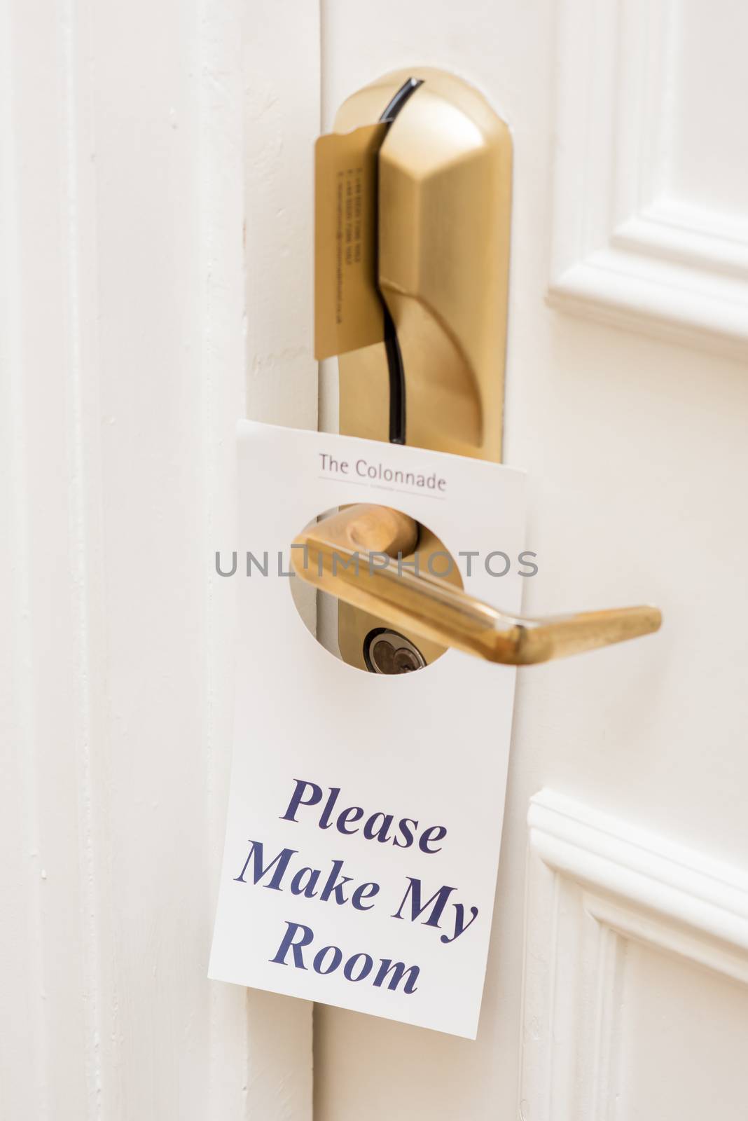Sign hangs on a door handle. by stockyimages