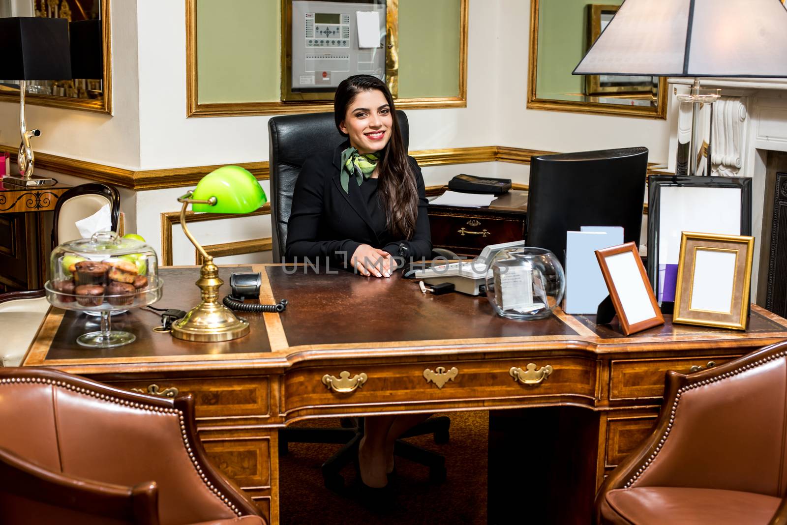 Happy professional woman receptionist in a hotel