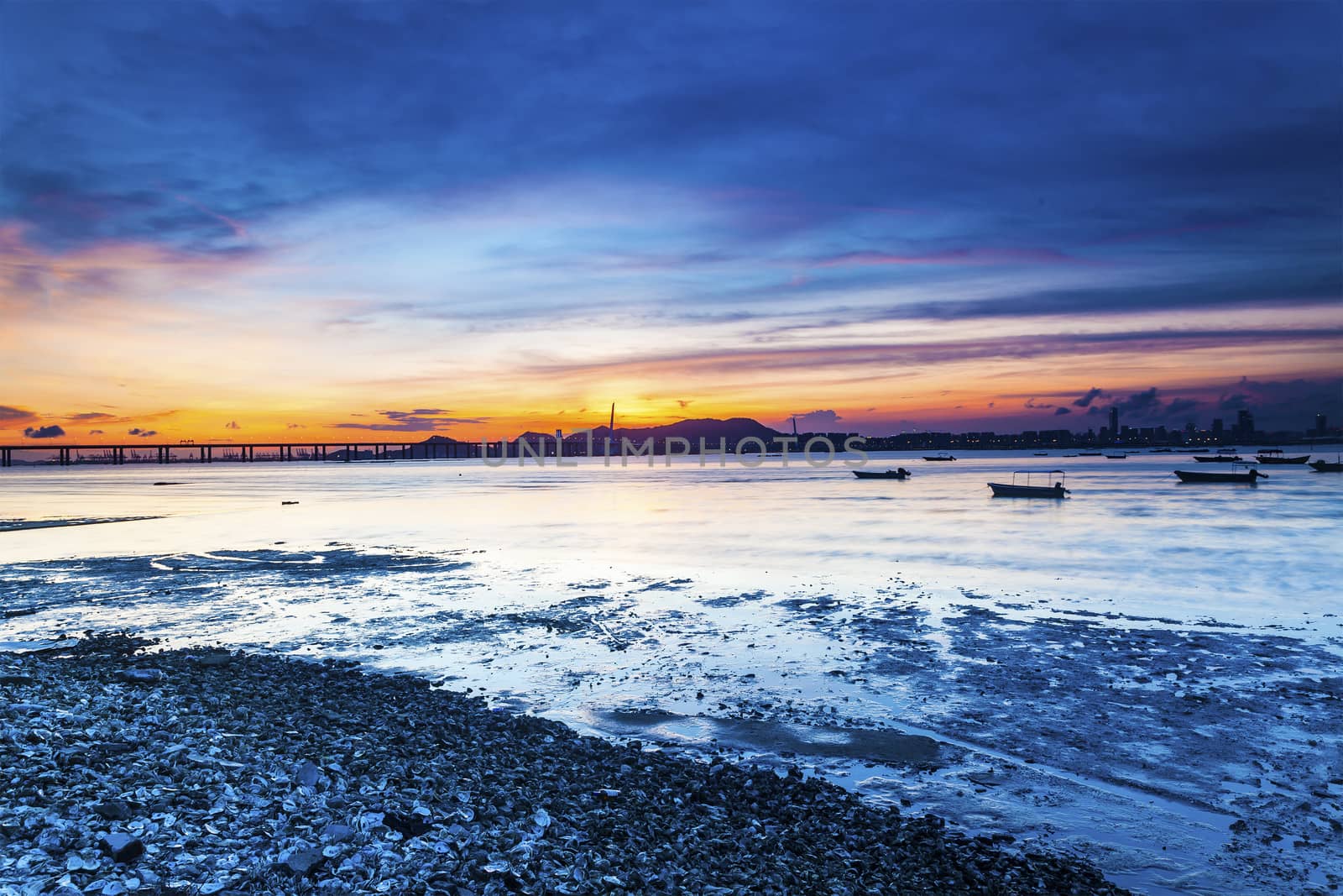 Sunset coast with a bridge connecting opposite side by kawing921