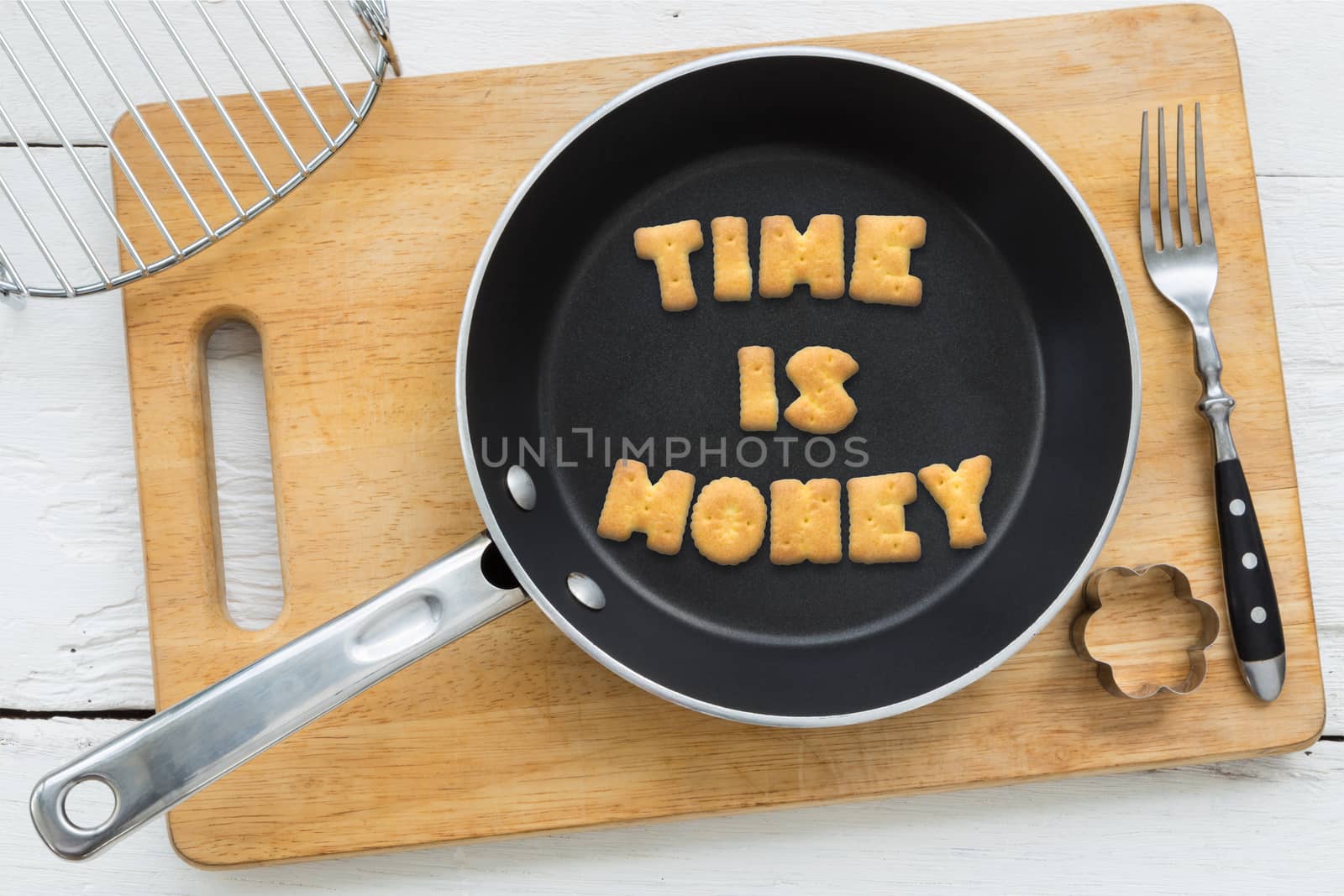 Letter biscuits quote TIME IS MONEY and cooking equipments. by vinnstock