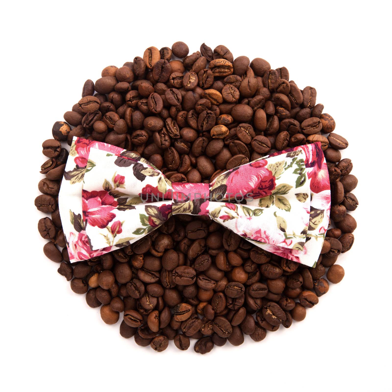flower colors bow tie lie on the circle of coffee beans isolated on white background