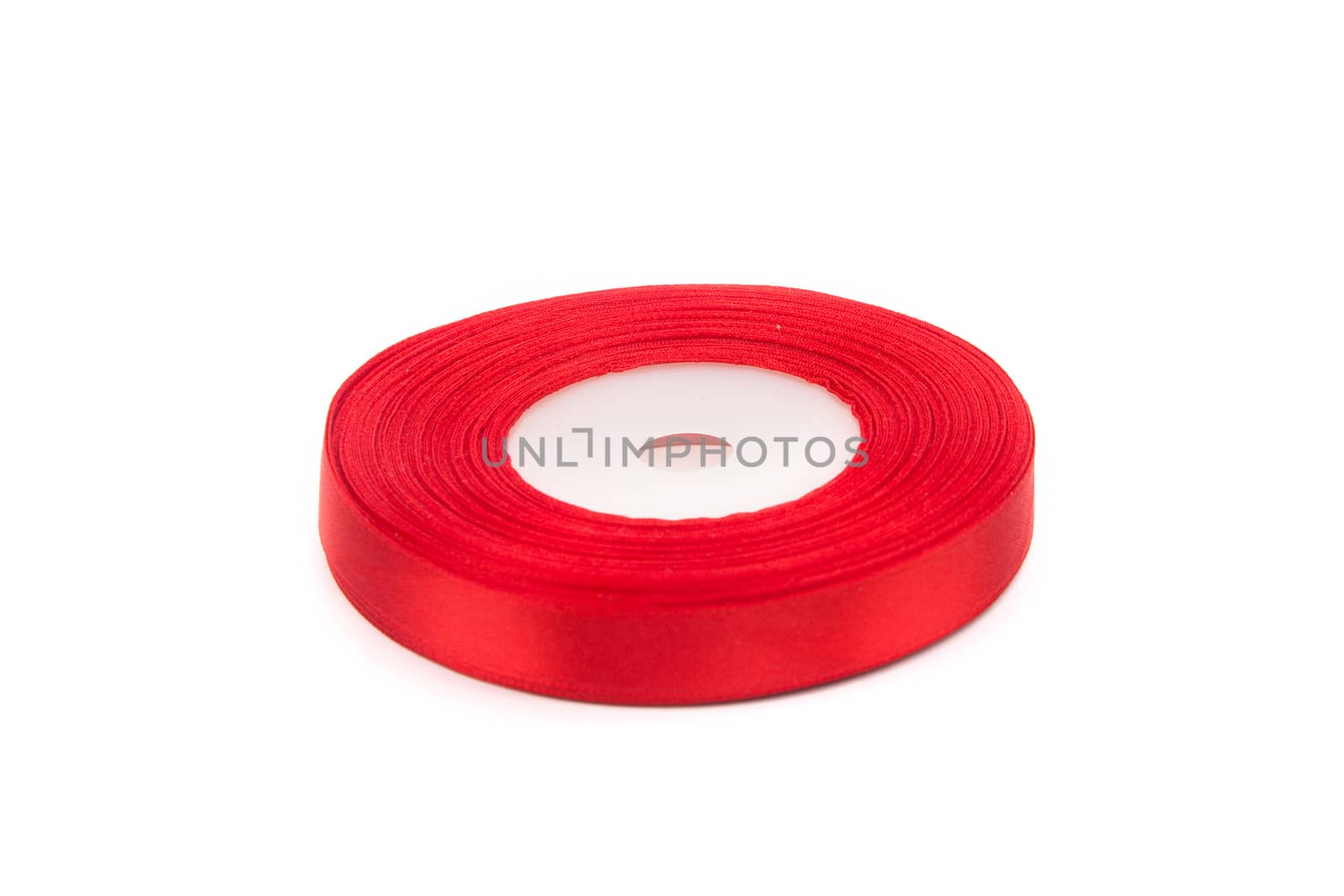 skein of red ribbon on white background