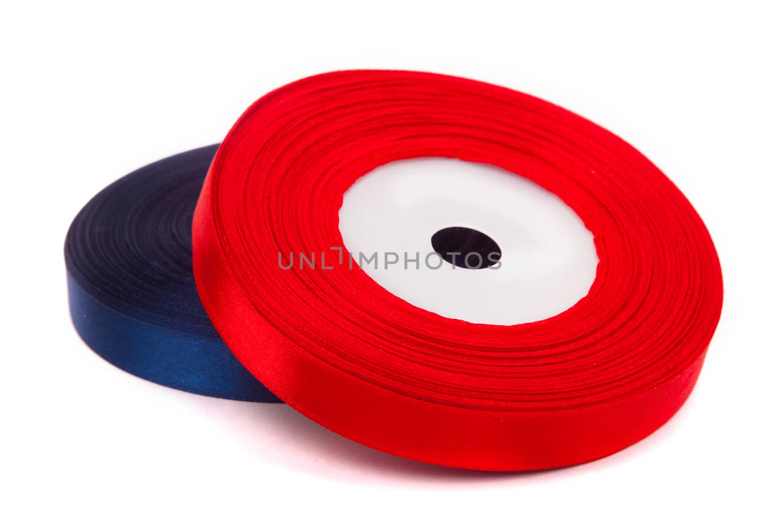 skein of red ribbon on white background