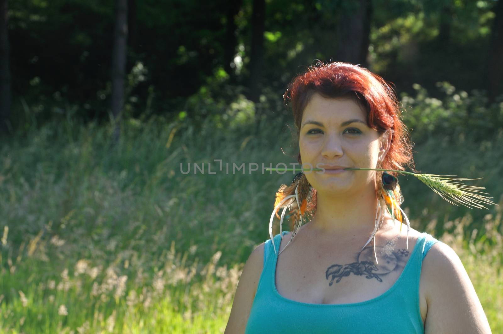 portrait of red  hair woman with strand of wheat