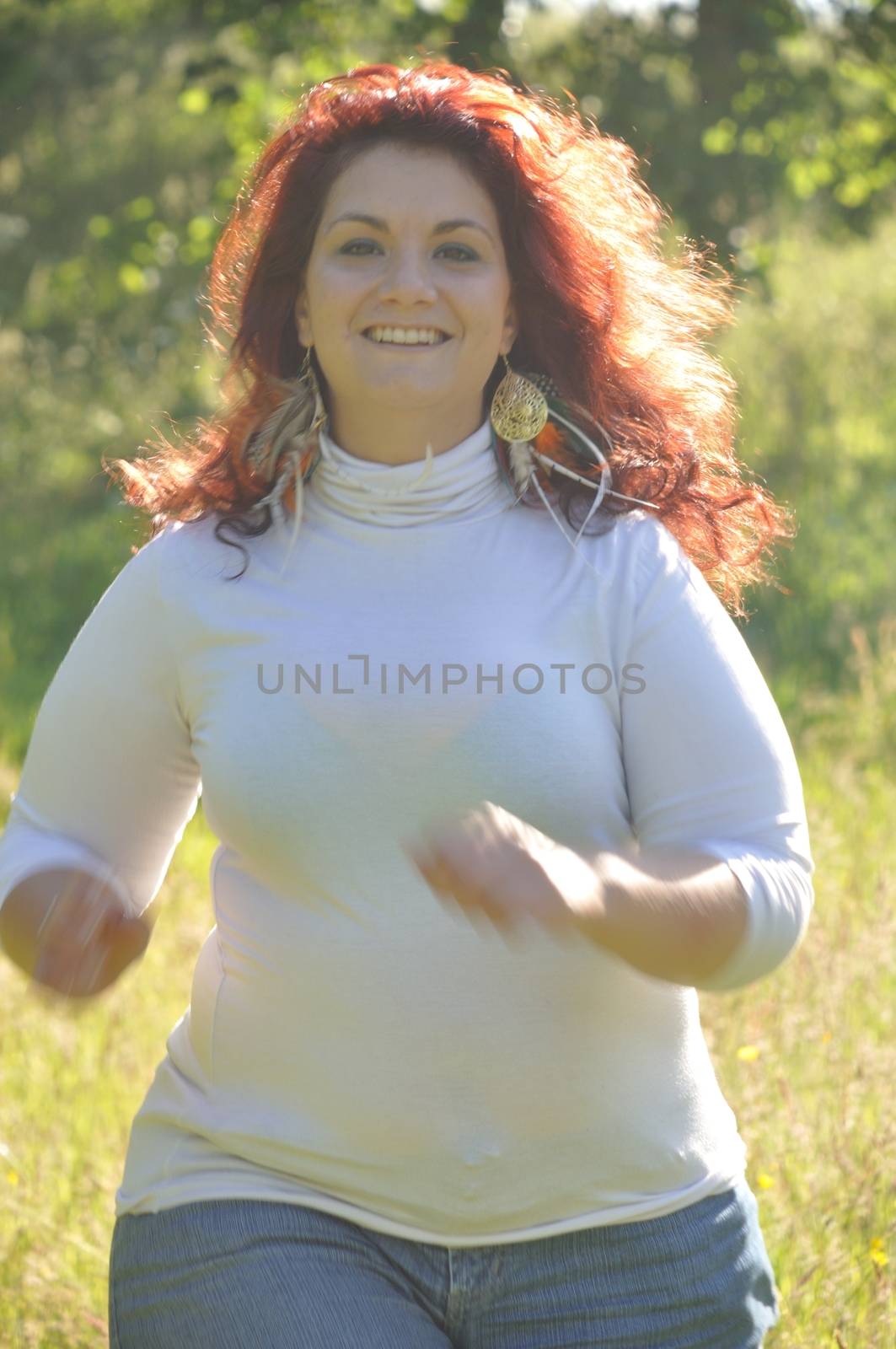Woman running in a meadow 