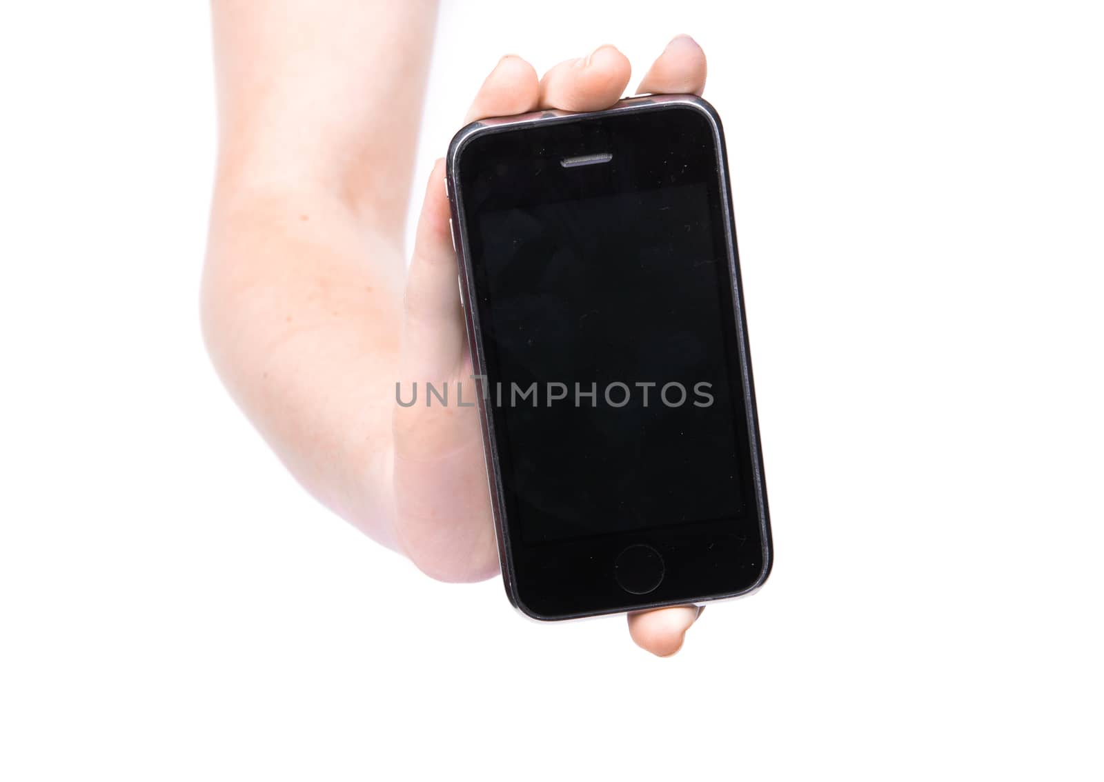 Female hand holding a phone on an isolated white background