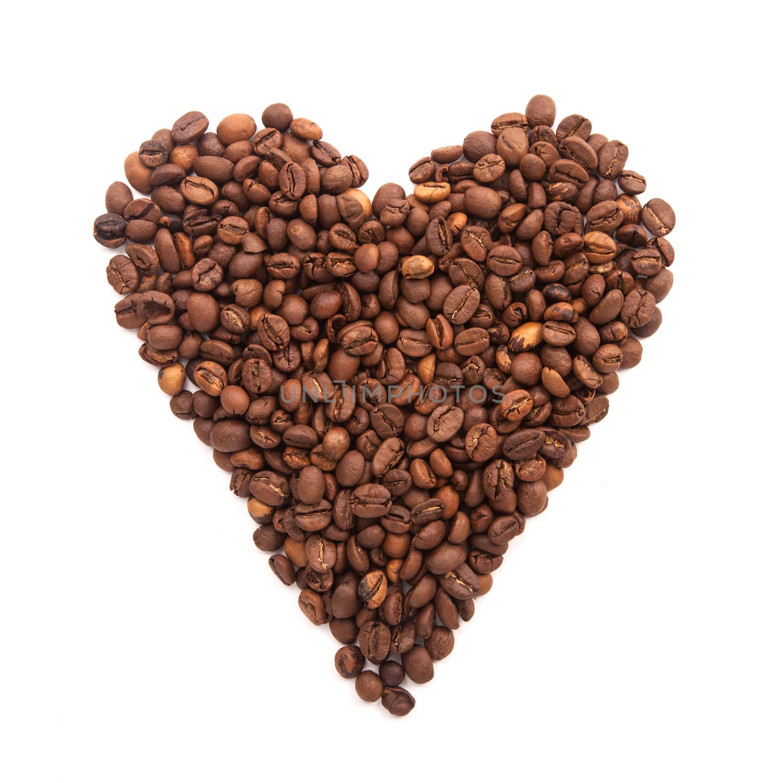 roasted coffee laid out in the form of heart isolated on white background by traza