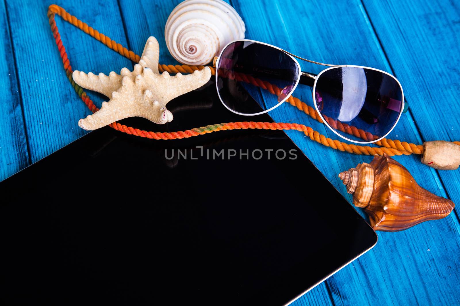 background summer mood. tablet and sunglasses