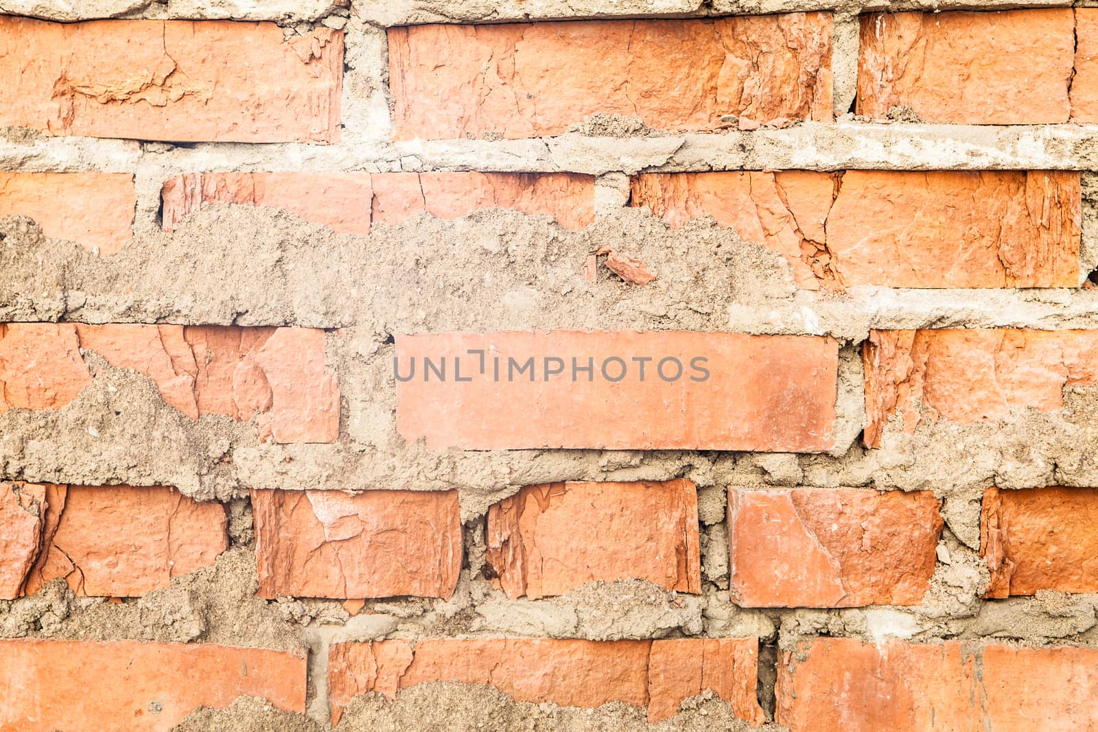 Background of old wall of red brick with clay masonry scuffed