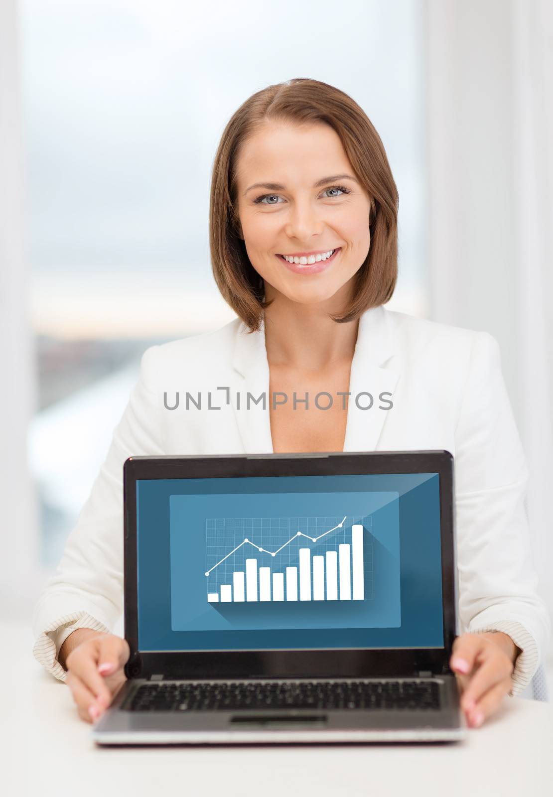 education, business, technology and internet concept - smiling woman with laptop computer in office
