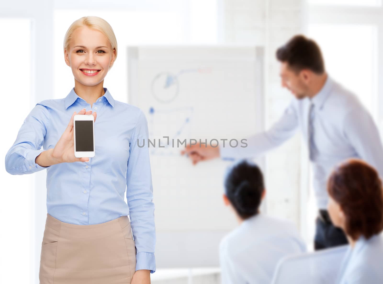 smiling businesswoman with smartphone blank screen by dolgachov