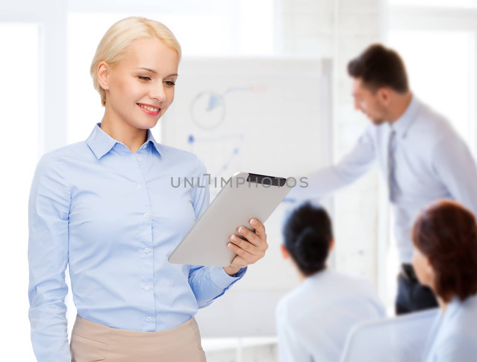 business, internet and technology concept - smiling woman looking at tablet pc computer