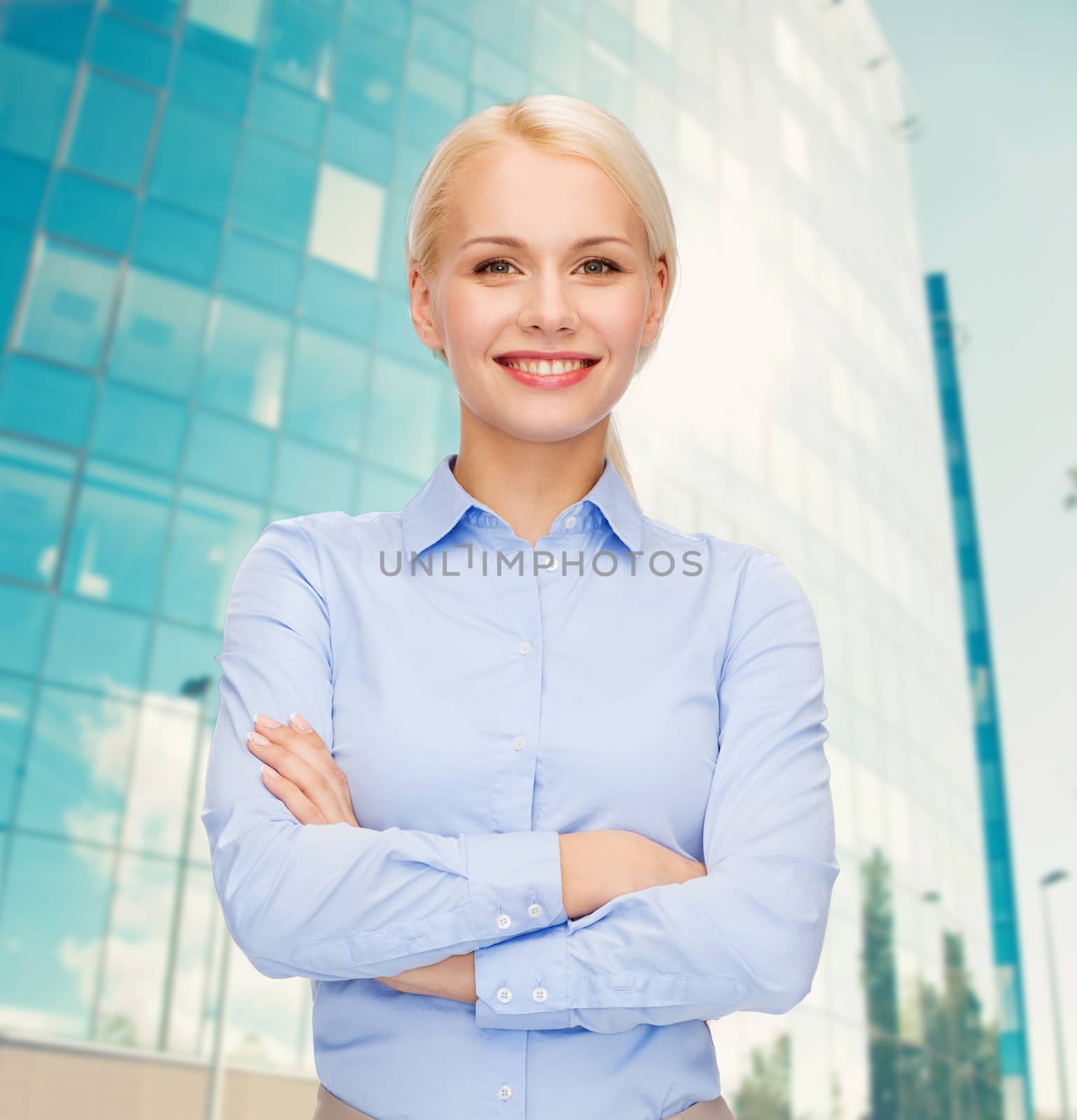 young smiling businesswoman with crossed arms by dolgachov