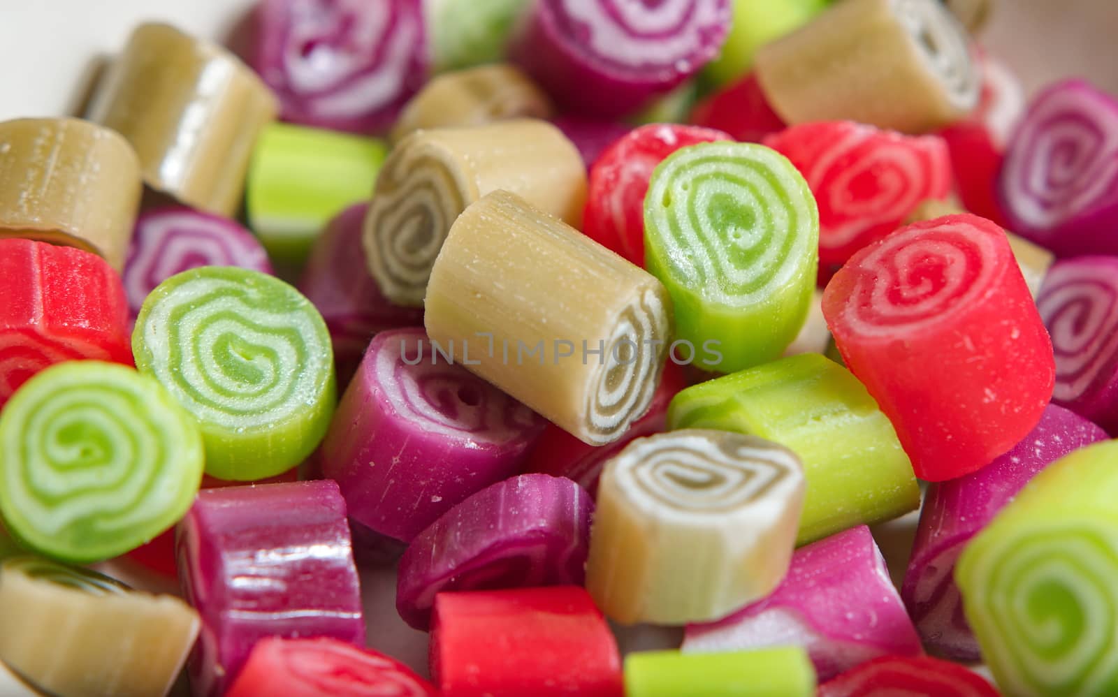 Colorful candies on white background by anderm