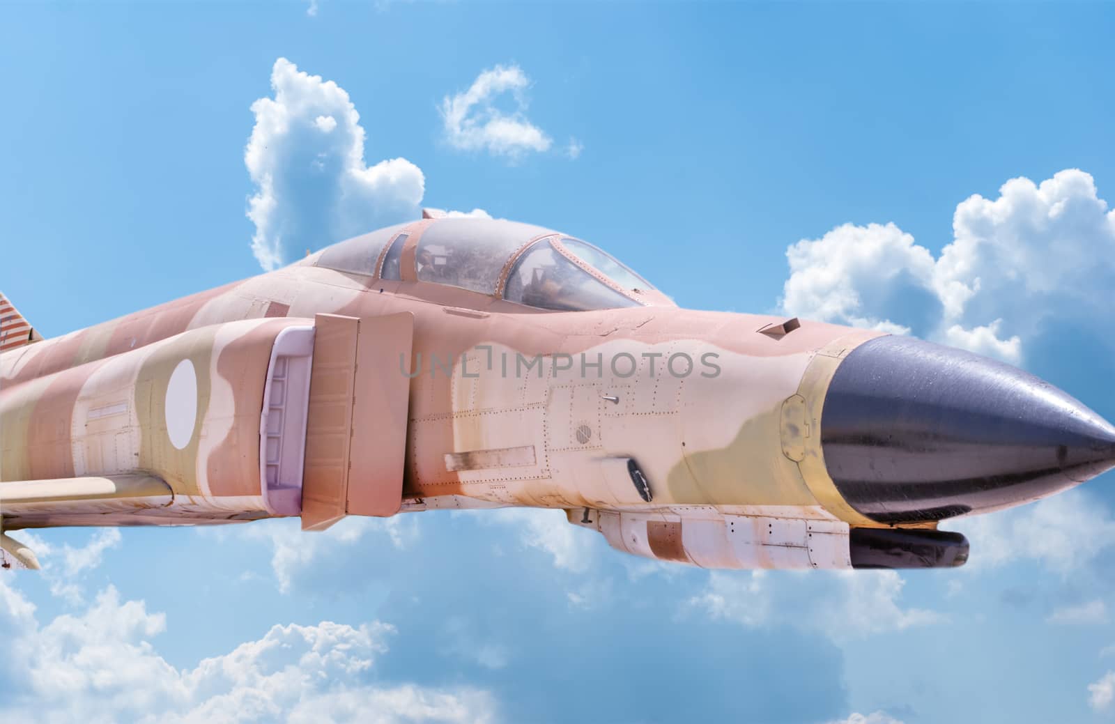 Fighter aircraft nose and cabin detail with blue sky background