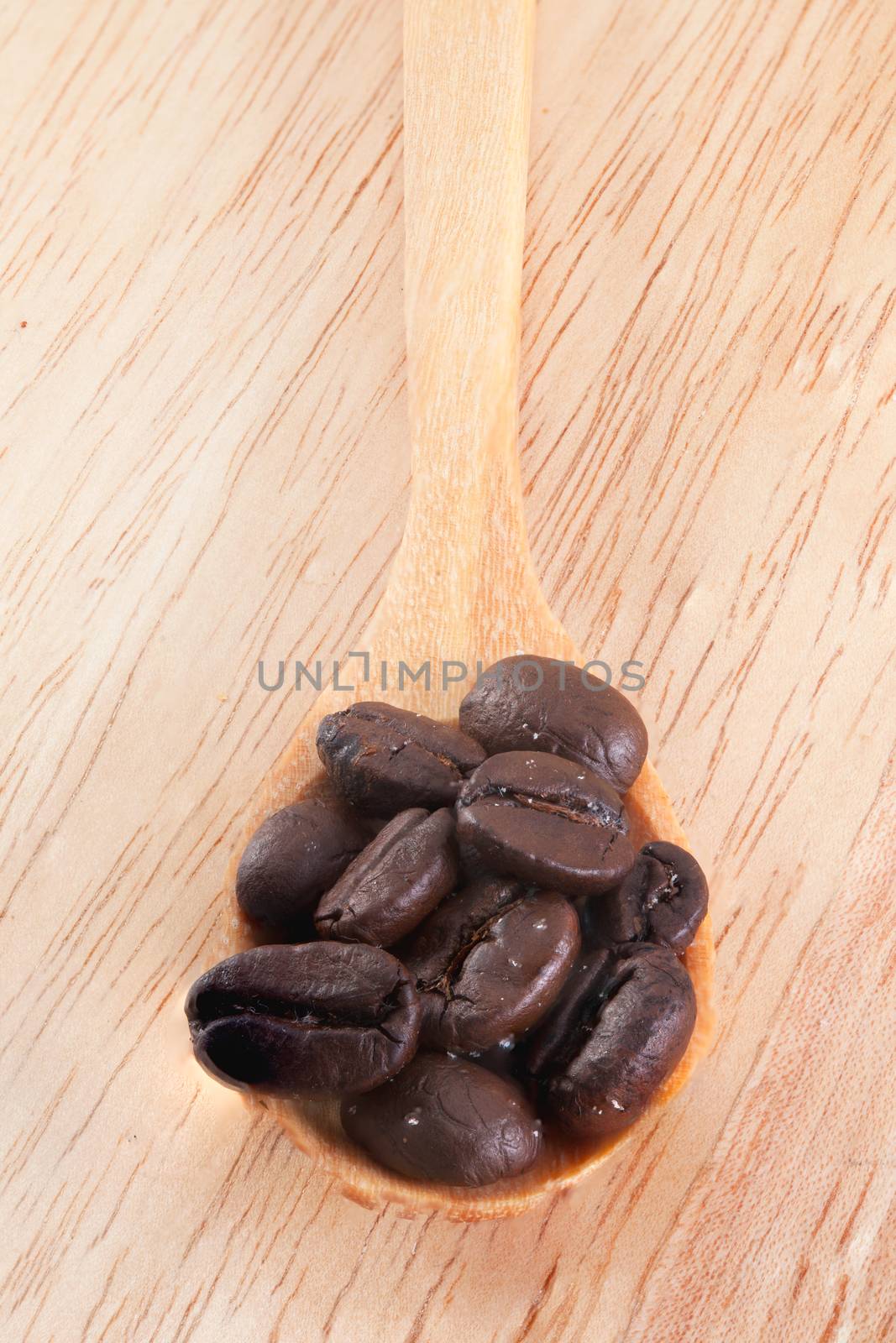 Fresh coffee beans arrangement put in wooden plates.