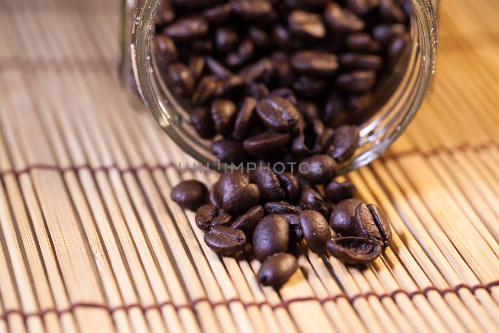 Coffee beans in a glass jar by a454