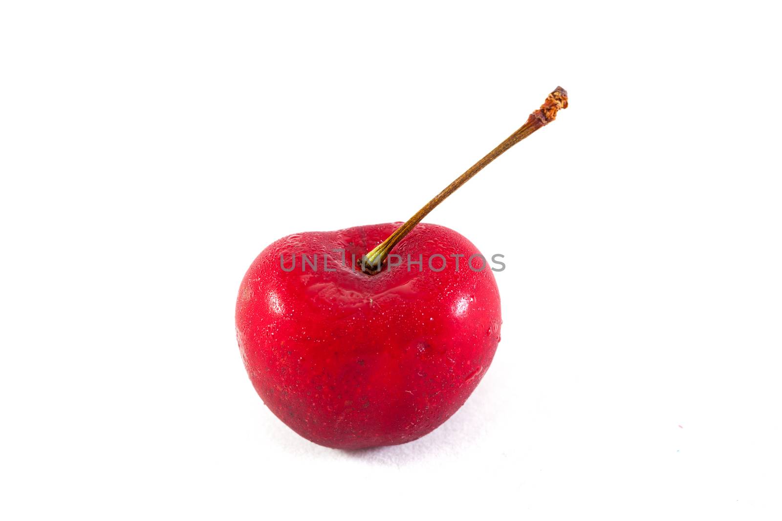 Cherry on a white background. The Cherry red on a white background in the studio. Cut deployed.