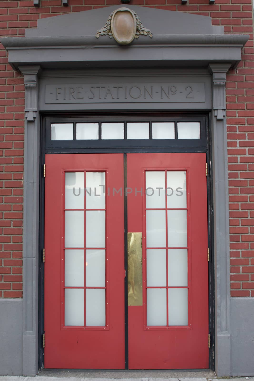 Fire Station No 2 Sign about a red door with windows