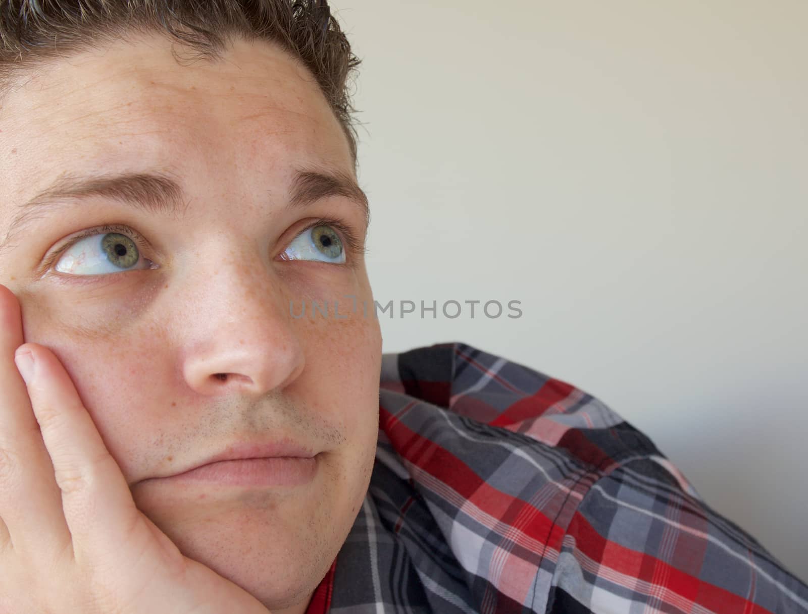 Young Man Looking Up with Green Eyes