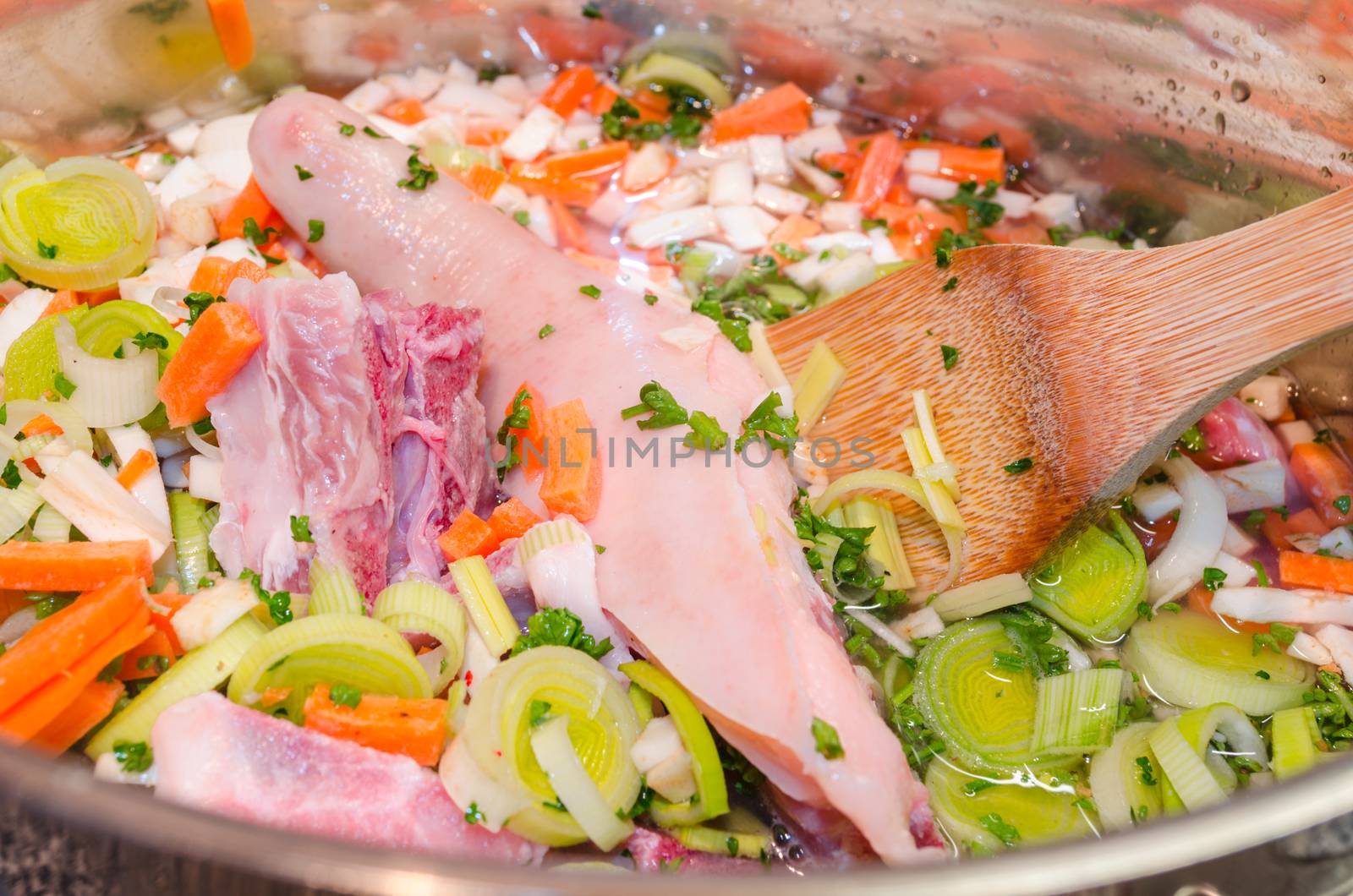 Delicious stew in an open pot, top view
