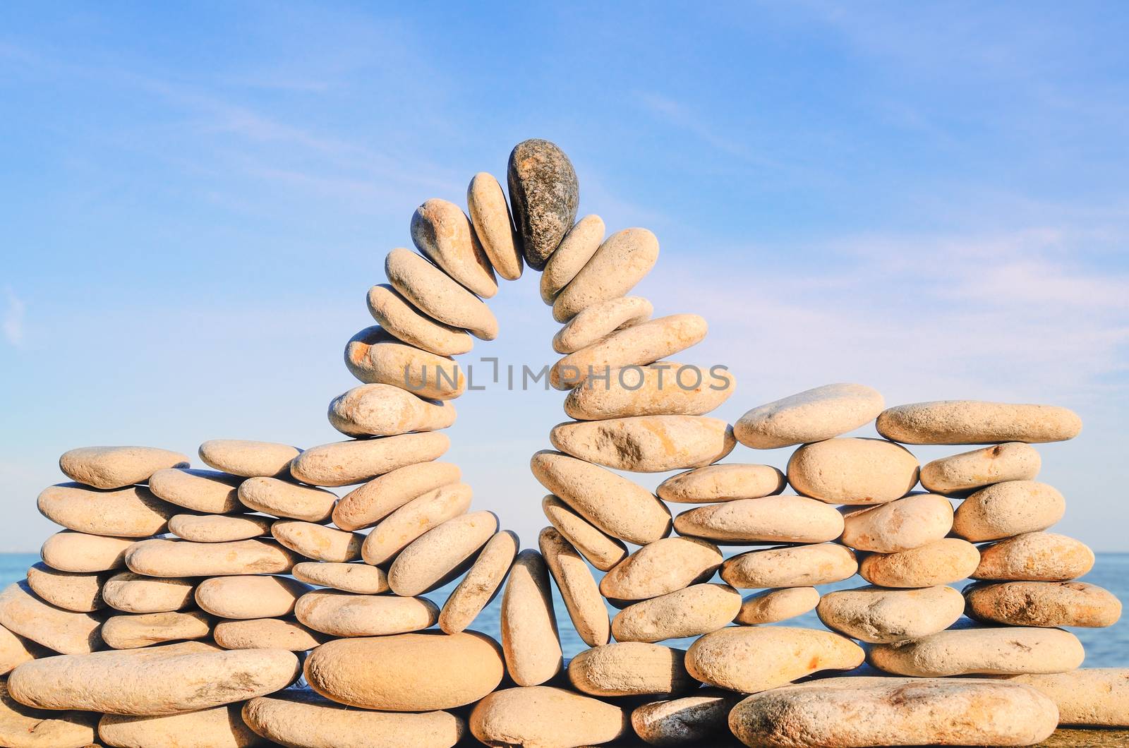 Arch of pebbles between of the stones on the seashore