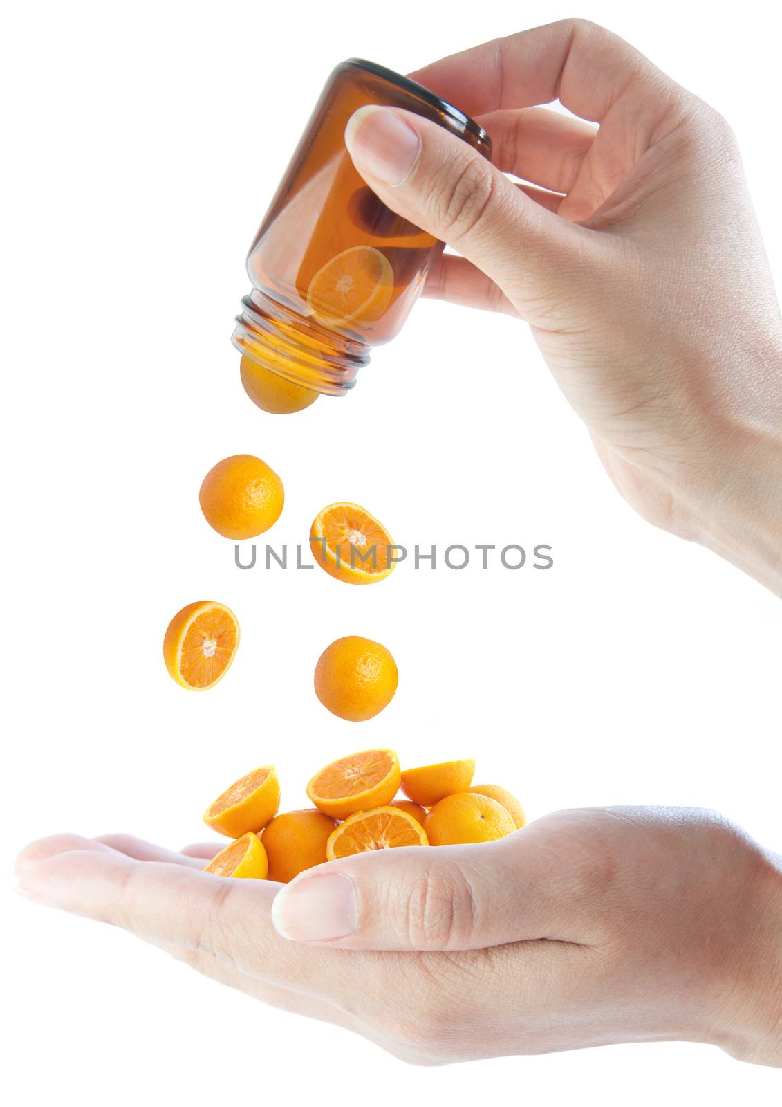 Many oranges falling out of a vitamin jar 
