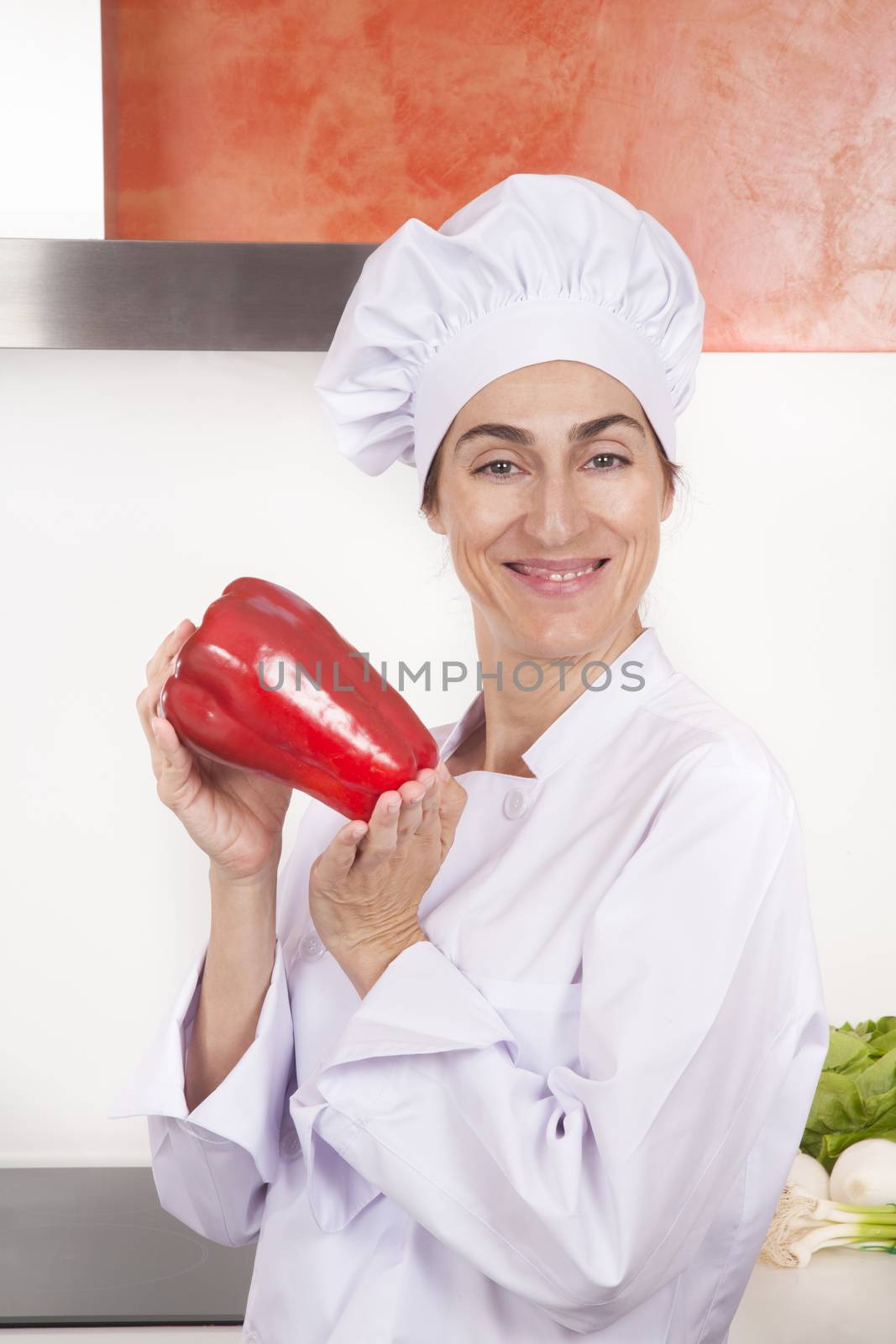 happy woman chef with pepper by quintanilla