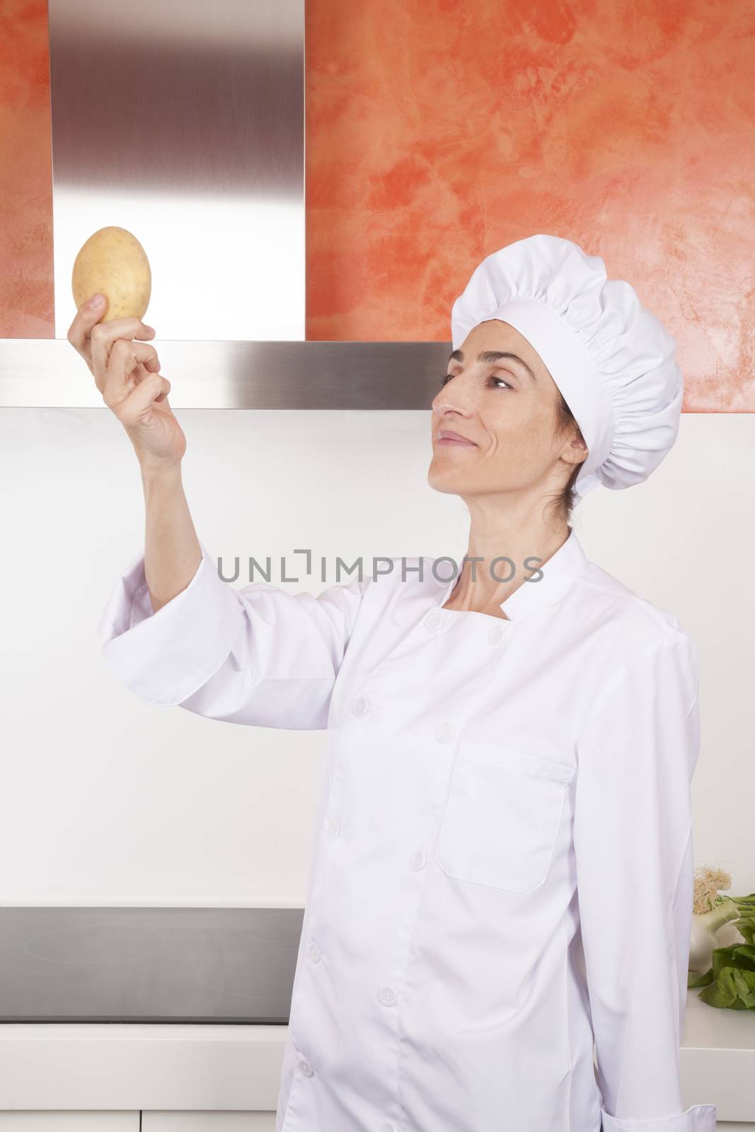 smiling woman chef with potato by quintanilla