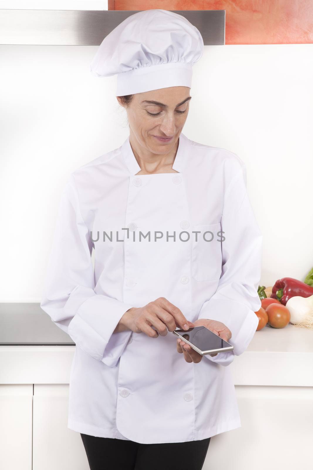 woman chef using screen blank phone by quintanilla